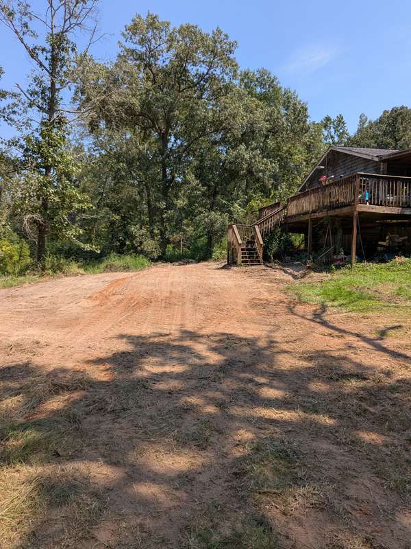 Graded red clay site after excavation - Lonestar Landworks Kilgore TX